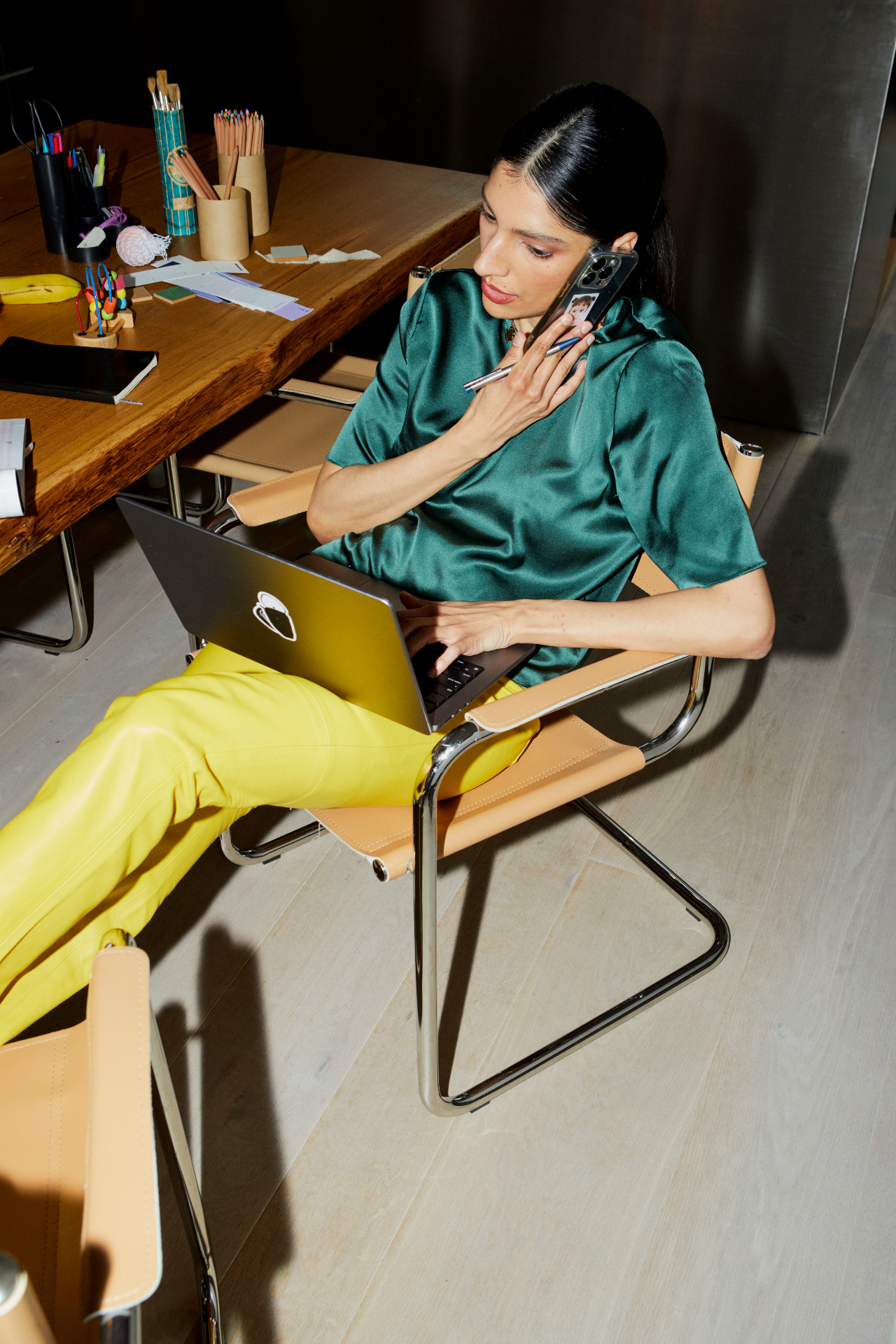 HR professional multitasking on a phone and laptop