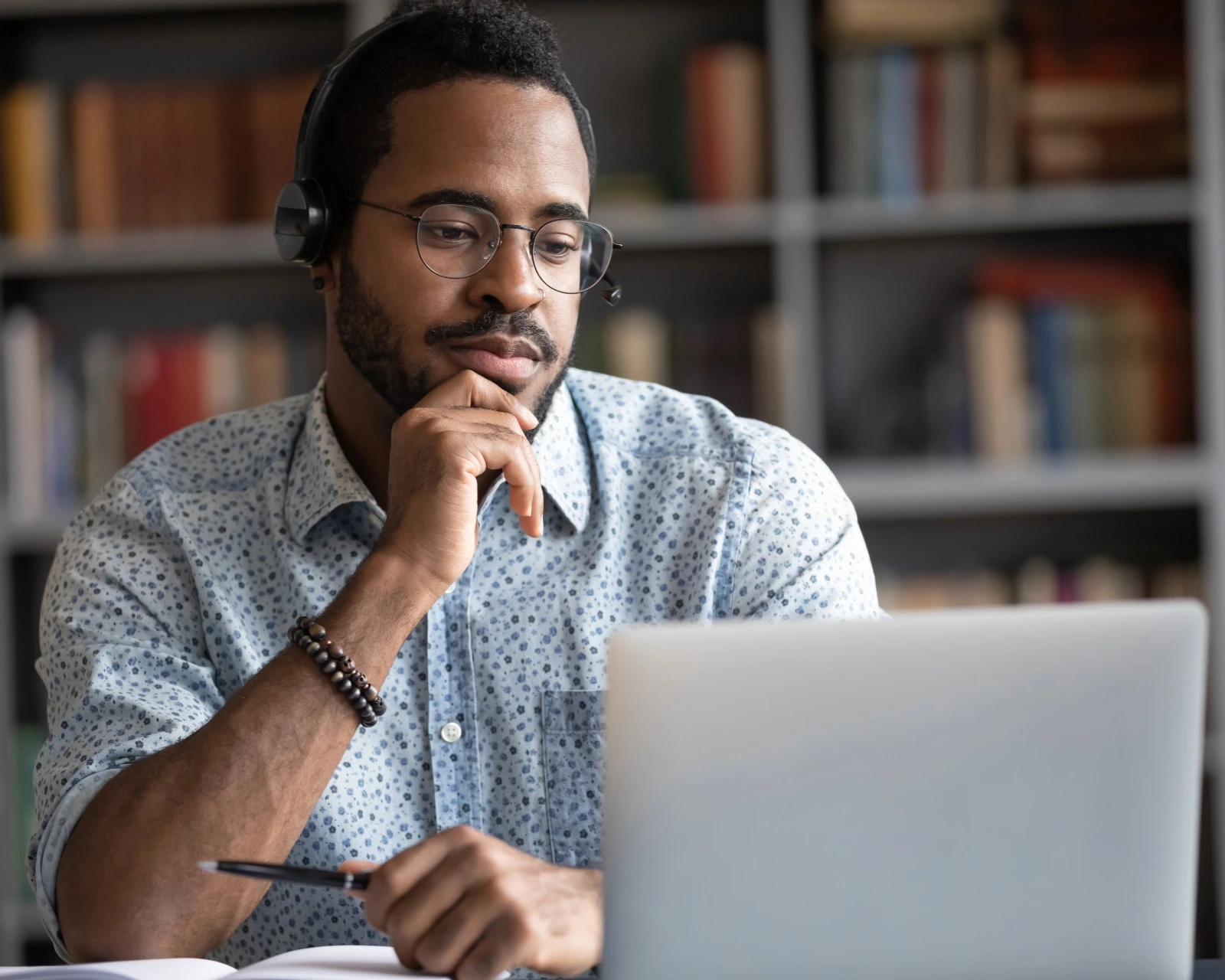 Professional in an online training session with headphones and notebook